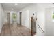 Bright hallway with hardwood floors, white walls, and modern staircase at 32 Wadley Nw St, Atlanta, GA 30314