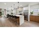 Bright kitchen features a large island with seating, stainless steel appliances, and modern pendant lighting at 32 Wadley Nw St, Atlanta, GA 30314