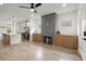 Open-concept living area with a fireplace, modern kitchen, and hardwood floors at 32 Wadley Nw St, Atlanta, GA 30314