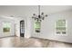 Bright and airy living room with stylish chandelier, modern flooring, and large windows at 32 Wadley Nw St, Atlanta, GA 30314