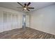 Bright bedroom featuring wood-look floors, a ceiling fan, and closet space at 4593 Bexley Way, Stone Mountain, GA 30083