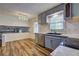 Modern kitchen featuring gray cabinets and stainless steel sink at 4593 Bexley Way, Stone Mountain, GA 30083