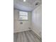 Clean laundry room with wood-look floors, a window for natural light, and washer/dryer hookups at 4593 Bexley Way, Stone Mountain, GA 30083