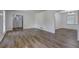 Open-concept living room with modern flooring and views into the dining area and entry at 4593 Bexley Way, Stone Mountain, GA 30083