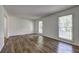 Bright, open living room with two windows and newly installed hardwood floors at 4593 Bexley Way, Stone Mountain, GA 30083