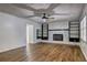 Cozy living room featuring a fireplace with built-in shelving and wood-look floors at 4593 Bexley Way, Stone Mountain, GA 30083