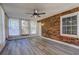 Bright sunroom featuring wood-look floors, windows, and brick accent wall at 4593 Bexley Way, Stone Mountain, GA 30083