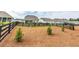 Expansive backyard featuring a charming black fence and newly planted trees at 98 Heritage Pointe Dr, Villa Rica, GA 30180