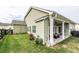 Backyard view with a covered patio, green lawn, and dark wooden fencing at 98 Heritage Pointe Dr, Villa Rica, GA 30180