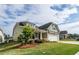 Inviting home exterior showcasing the lush lawn and landscaping with a partial view of the driveway at 98 Heritage Pointe Dr, Villa Rica, GA 30180