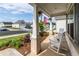 Cozy front porch view with rocking chairs and a glimpse of the neighborhood street at 98 Heritage Pointe Dr, Villa Rica, GA 30180