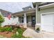 Inviting front porch with decorative plants, rocking chairs, and an American flag at 98 Heritage Pointe Dr, Villa Rica, GA 30180