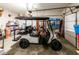 Brightly lit garage featuring a golf cart and generous shelving at 98 Heritage Pointe Dr, Villa Rica, GA 30180