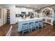 An elegant kitchen features white cabinets, stainless appliances, an island with seating, and a walk-in pantry at 98 Heritage Pointe Dr, Villa Rica, GA 30180