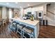 Bright kitchen with white cabinets, stainless steel appliances, large island with bar seating, and hardwood floors at 98 Heritage Pointe Dr, Villa Rica, GA 30180