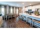 A kitchen and dining area features white cabinets, stainless steel appliances, an island, and hardwood floors at 98 Heritage Pointe Dr, Villa Rica, GA 30180