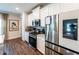 A kitchen with white cabinets, stainless steel appliances, modern backsplash, and hardwood floors at 98 Heritage Pointe Dr, Villa Rica, GA 30180