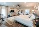 A spacious main bedroom features a king bed, ceiling fan, hardwood floors, and a sitting area at 98 Heritage Pointe Dr, Villa Rica, GA 30180