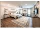 A spacious main bedroom features a king-size bed, sitting area, a ceiling fan, and wood-look floors at 98 Heritage Pointe Dr, Villa Rica, GA 30180