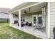 Inviting covered patio with a brick fireplace and comfortable seating area at 98 Heritage Pointe Dr, Villa Rica, GA 30180