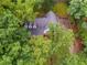 Aerial view of the roof and backyard in a wooded neighborhood at 2055 Timberland Dr, Cumming, GA 30040