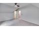 Attic room featuring carpeting, ceiling fan and multiple doors at 2055 Timberland Dr, Cumming, GA 30040