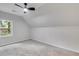 Neutral attic room featuring carpeting, ceiling fan, and large windows at 2055 Timberland Dr, Cumming, GA 30040
