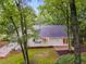 Landscaped backyard with patio area and a lovely view of the trees behind this two-story home at 2055 Timberland Dr, Cumming, GA 30040