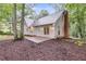 Backyard features a patio and updated exterior lighting in this two-story home with a brick chimney at 2055 Timberland Dr, Cumming, GA 30040