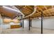 Large basement area with kitchenette and exposed ceiling, perfect for customization at 2055 Timberland Dr, Cumming, GA 30040