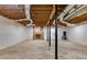 Spacious unfinished basement with exposed beams and brick fireplace awaiting your design at 2055 Timberland Dr, Cumming, GA 30040