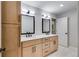 Bathroom featuring a double vanity with modern lighting and ample storage at 2055 Timberland Dr, Cumming, GA 30040