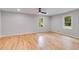 Spacious bedroom featuring hardwood floors, a ceiling fan, and ample natural light at 2055 Timberland Dr, Cumming, GA 30040