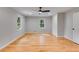 Bright bedroom with hardwood floors, neutral walls, and natural light from two windows at 2055 Timberland Dr, Cumming, GA 30040