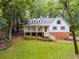 Charming two-story home with a welcoming front porch and lush landscaping at 2055 Timberland Dr, Cumming, GA 30040