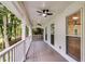 Covered porch with ceiling fans and views of the surrounding trees, creating an ideal outdoor retreat at 2055 Timberland Dr, Cumming, GA 30040