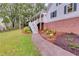 Landscaped yard with a walkway leading to the charming two-story home featuring a welcoming front porch at 2055 Timberland Dr, Cumming, GA 30040