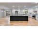 Modern kitchen featuring a large island, white cabinets, stainless steel appliances, and hardwood floors at 2055 Timberland Dr, Cumming, GA 30040