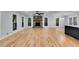 Spacious living area with fireplace, hardwood floors, ample windows, and a black kitchen island at 2055 Timberland Dr, Cumming, GA 30040