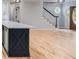 Living area with open floor plan, hardwood floors, and access to the kitchen and staircase at 2055 Timberland Dr, Cumming, GA 30040