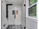 Modern walk-in shower with glass door and sleek, black fixtures at 2055 Timberland Dr, Cumming, GA 30040