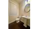 Cozy powder room featuring hardwood floors and a pedestal sink at 2431 Kingston Heath Way, Marietta, GA 30008