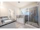 Bright bathroom featuring a double vanity with granite countertop, soaking tub, and glass-enclosed shower at 2431 Kingston Heath Way, Marietta, GA 30008