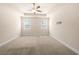 Spacious bedroom featuring a tray ceiling and natural light from the double windows at 2431 Kingston Heath Way, Marietta, GA 30008