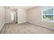 Spacious bedroom with neutral carpet, a window, and a door to another room at 2431 Kingston Heath Way, Marietta, GA 30008