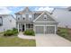 Charming two-story home with a well-manicured lawn and a two-car garage at 2431 Kingston Heath Way, Marietta, GA 30008