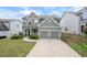 Charming home exterior with a two-car garage, well-maintained lawn, and inviting front porch at 2431 Kingston Heath Way, Marietta, GA 30008