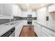Modern kitchen with white cabinets, granite countertops, and stainless steel appliances at 2431 Kingston Heath Way, Marietta, GA 30008