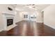 Open-concept living room with hardwood floors and fireplace, flowing into the kitchen at 2431 Kingston Heath Way, Marietta, GA 30008