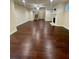 Spacious living room with hardwood floors, a fireplace, and access to the staircase at 2431 Kingston Heath Way, Marietta, GA 30008